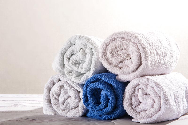 Premium Photo  Stack of clean towels on wooden table in bedroom